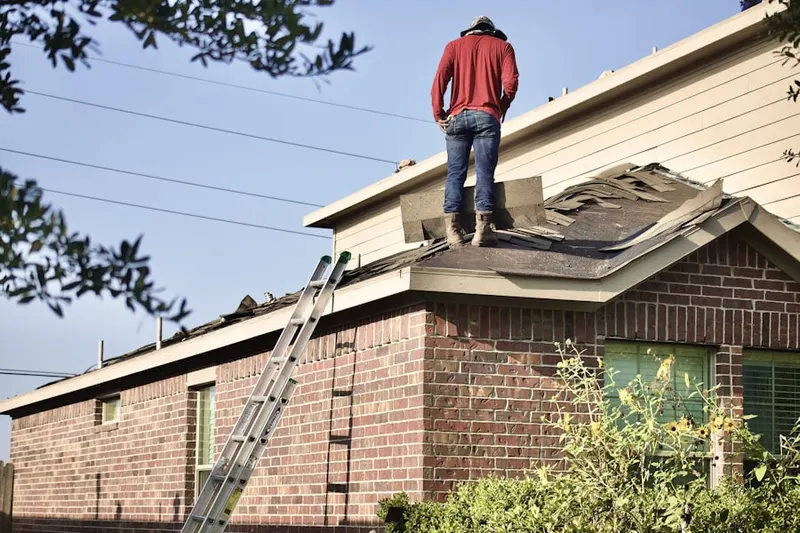 Professional roofer working on a residential roof in Summit View